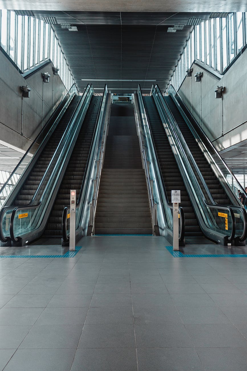 photo of stairs between escalators